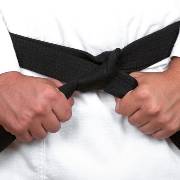 Karate students receiving new belts during promotion ceremony at Grubers Karate Gurnee, IL